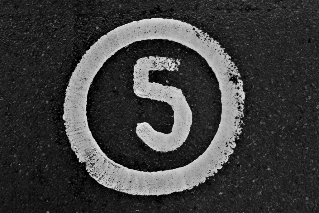 Number 5 with a circle, painted onto a road