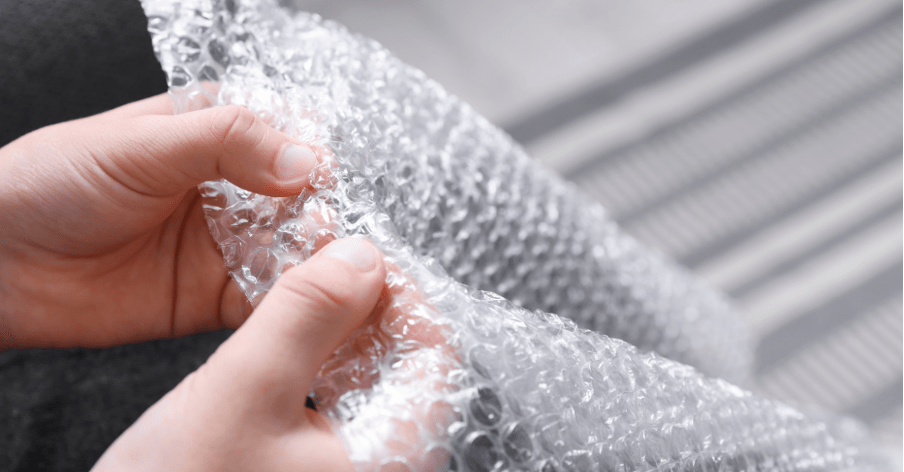 Person's hands playing with Bubble Wrap 